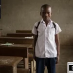 A young student stands in a classroom, representing the milestones and progress in Special Education in Georgia in 2026. This visual emphasizes the historical journey toward equitable access and the successful implementation of the Georgia Special Needs Scholarship (GSNS) Program, supported by expert insights from Special Ed Expert Ali and DP-HO.